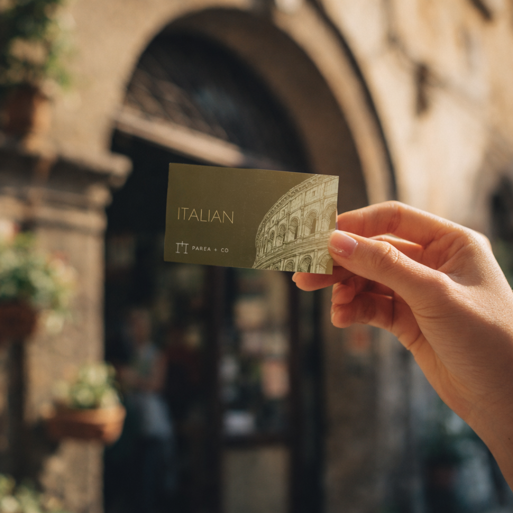 Hand holding Italian business card in sunlight.png