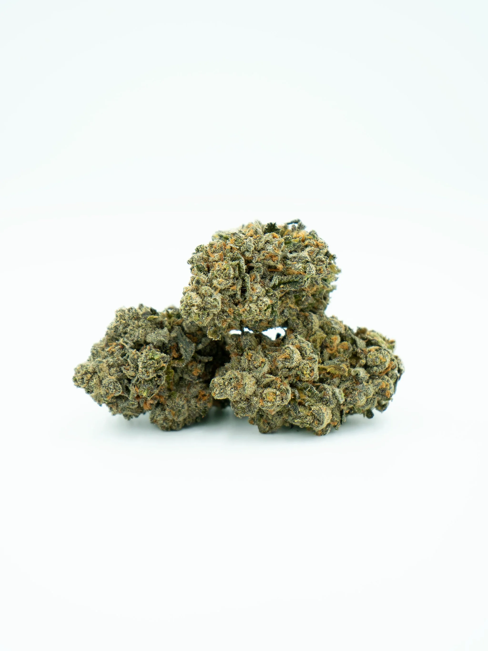 Close-up of three cannabis buds with frosty trichomes on a white background.