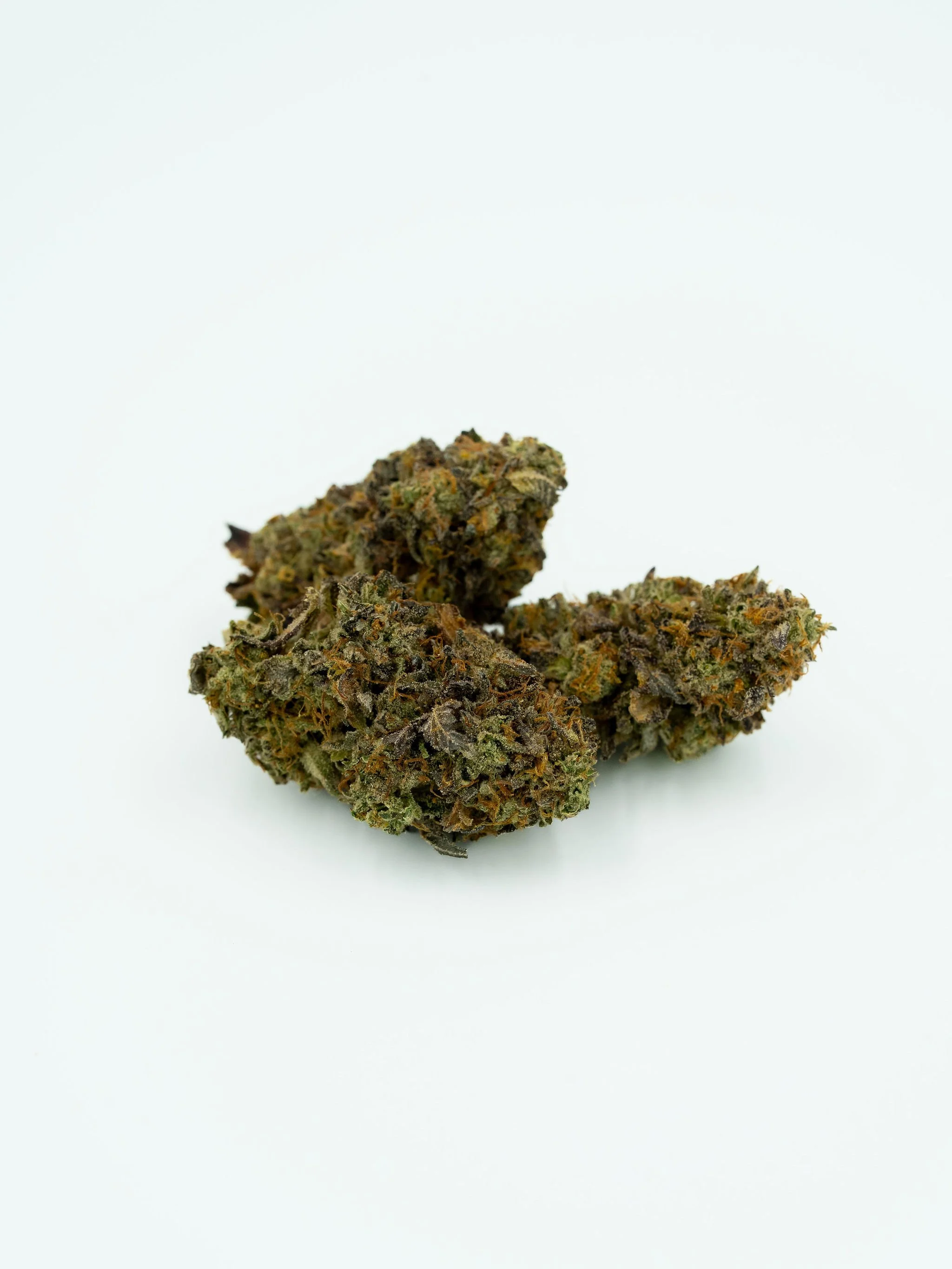 Close-up of cannabis buds on a white background.