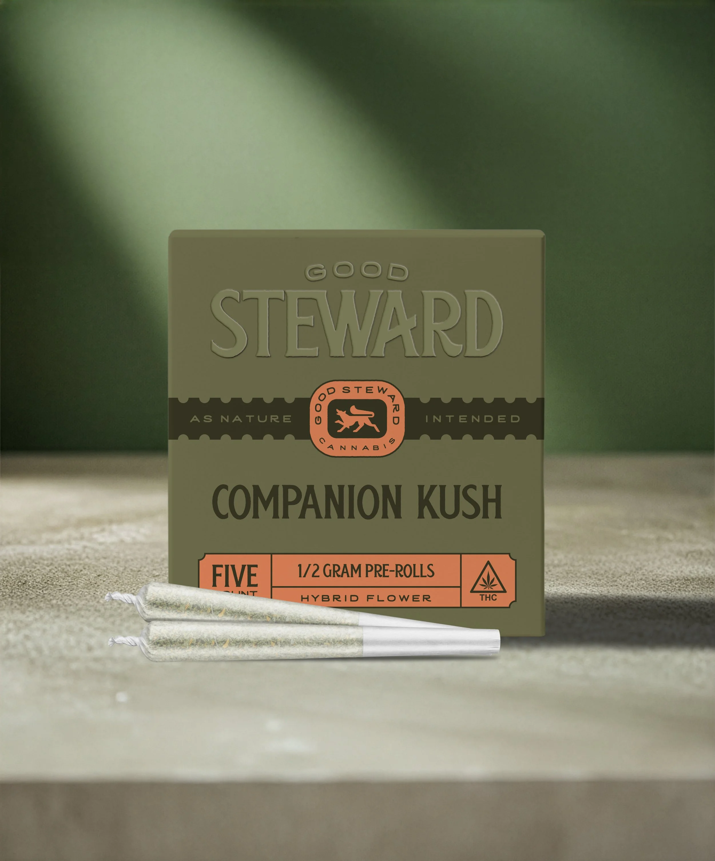 A box of Good Steward cannabis pre-rolls with three pre-rolled joints in front of it.