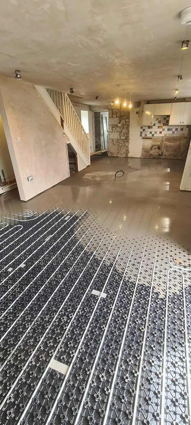 Underfloor heating pipe installation with liquid floor screed during home renovation by Tamar Construction in Cornwall.