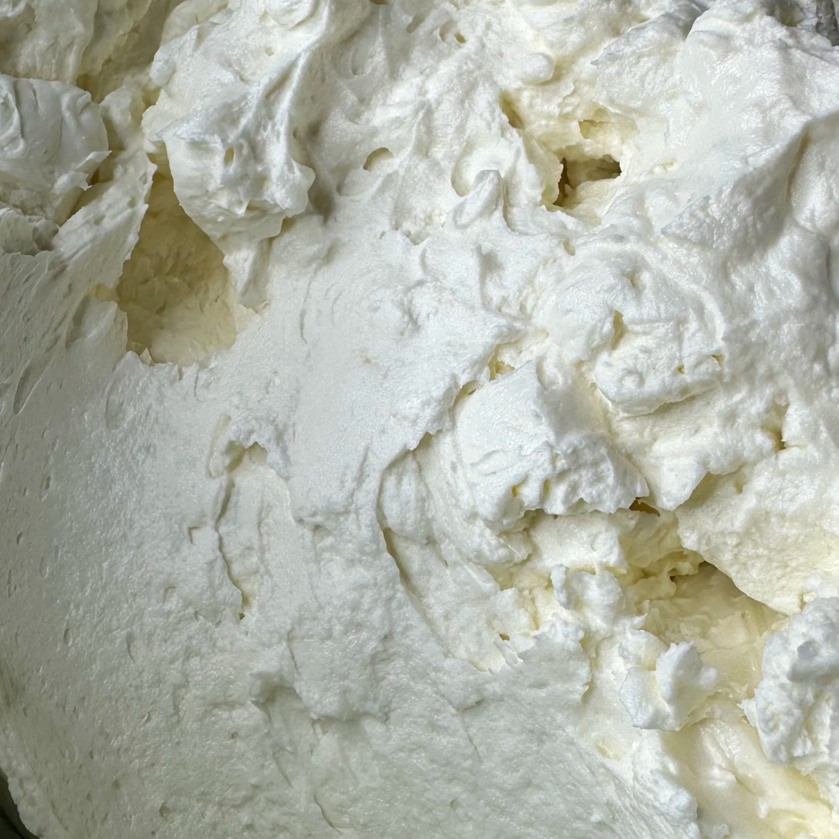 Close-up view of creamy, white whipped or whipped in a bowl.