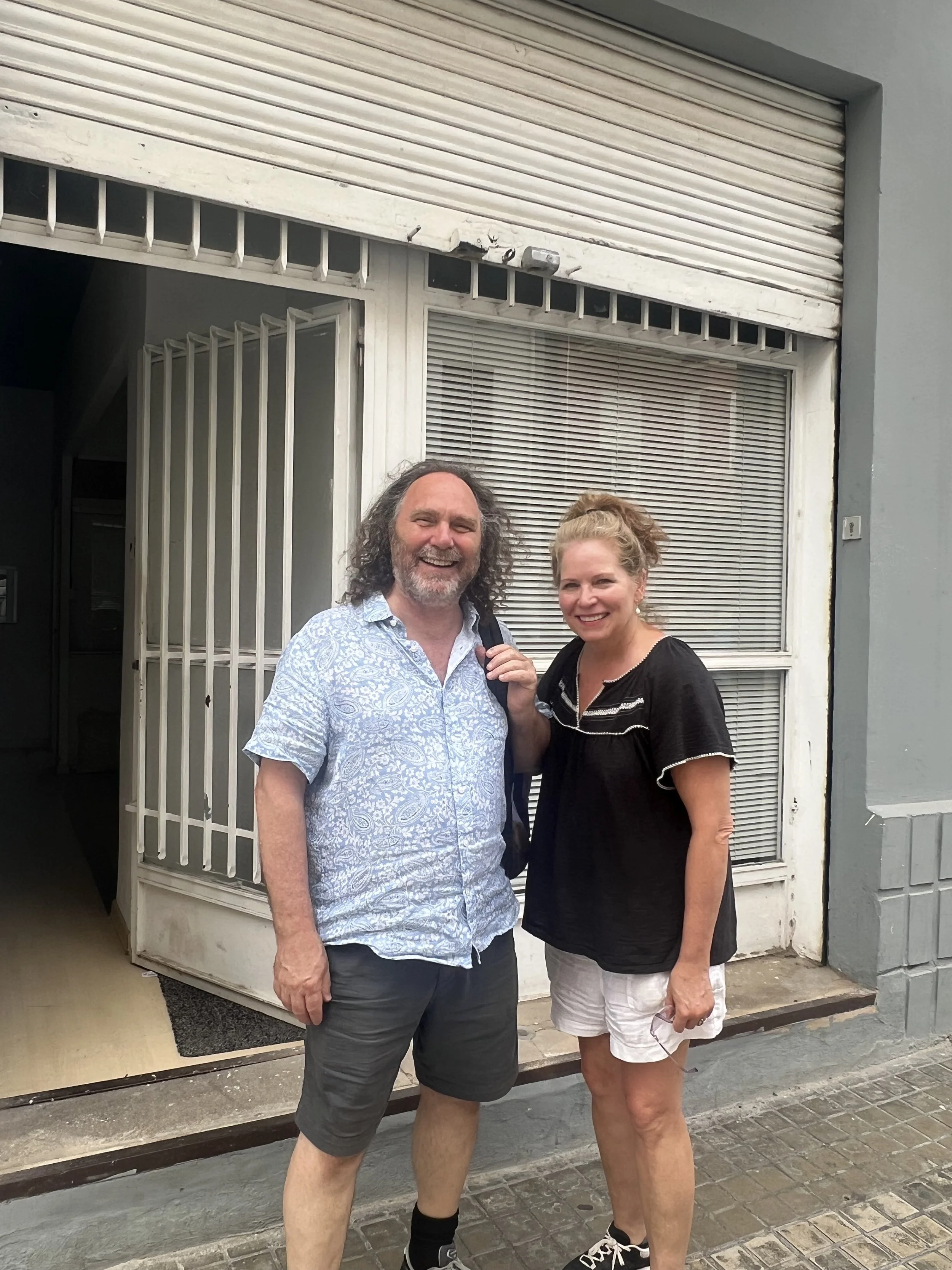 Cindy and Brian smiling in front of the entrance to the future Centre ValArts.