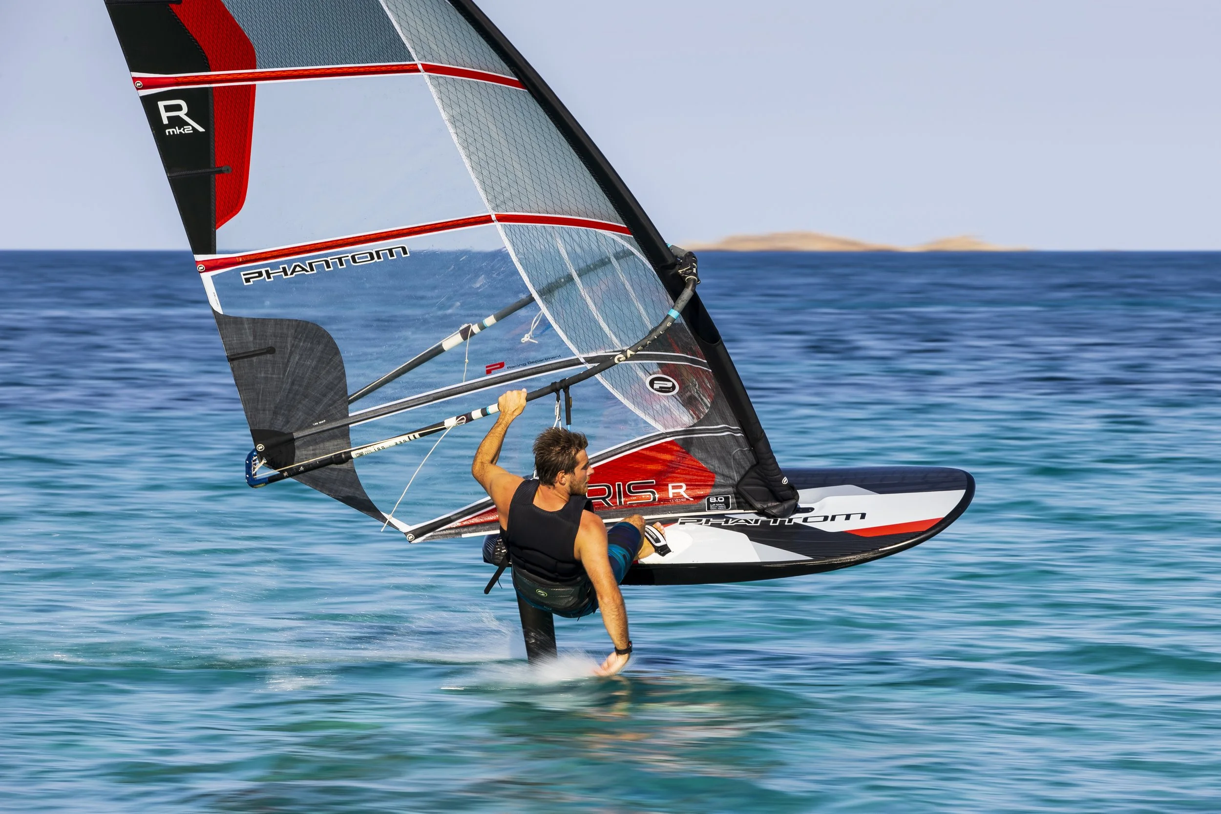 Man windsurfing on the ocean with a Phantom sail