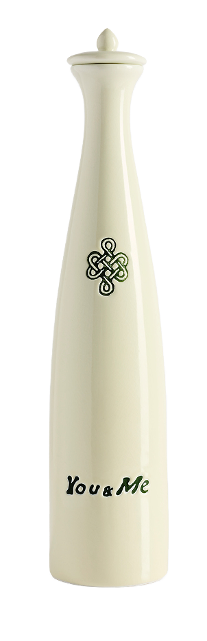 A tall, cream-colored ceramic salt shaker with a decorative design and the text "You & Me" on it.