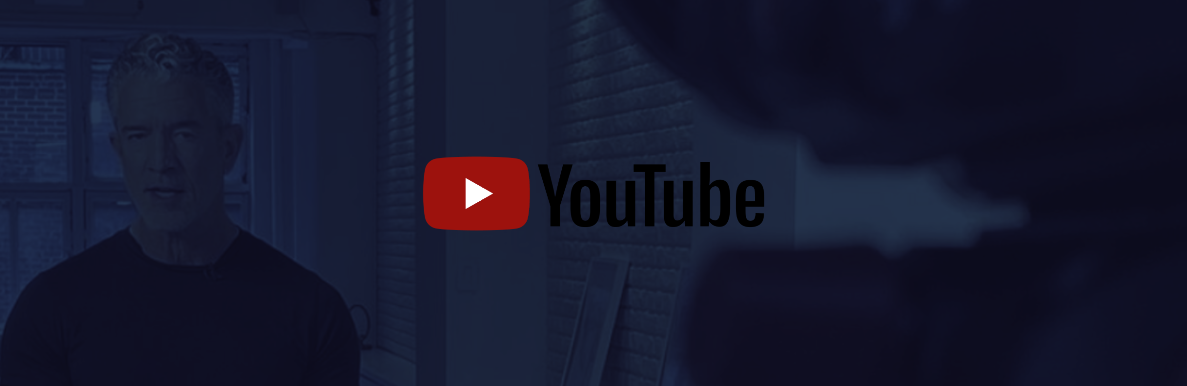 YouTube logo over a blurred image of a man standing indoors near a window with brick walls.
