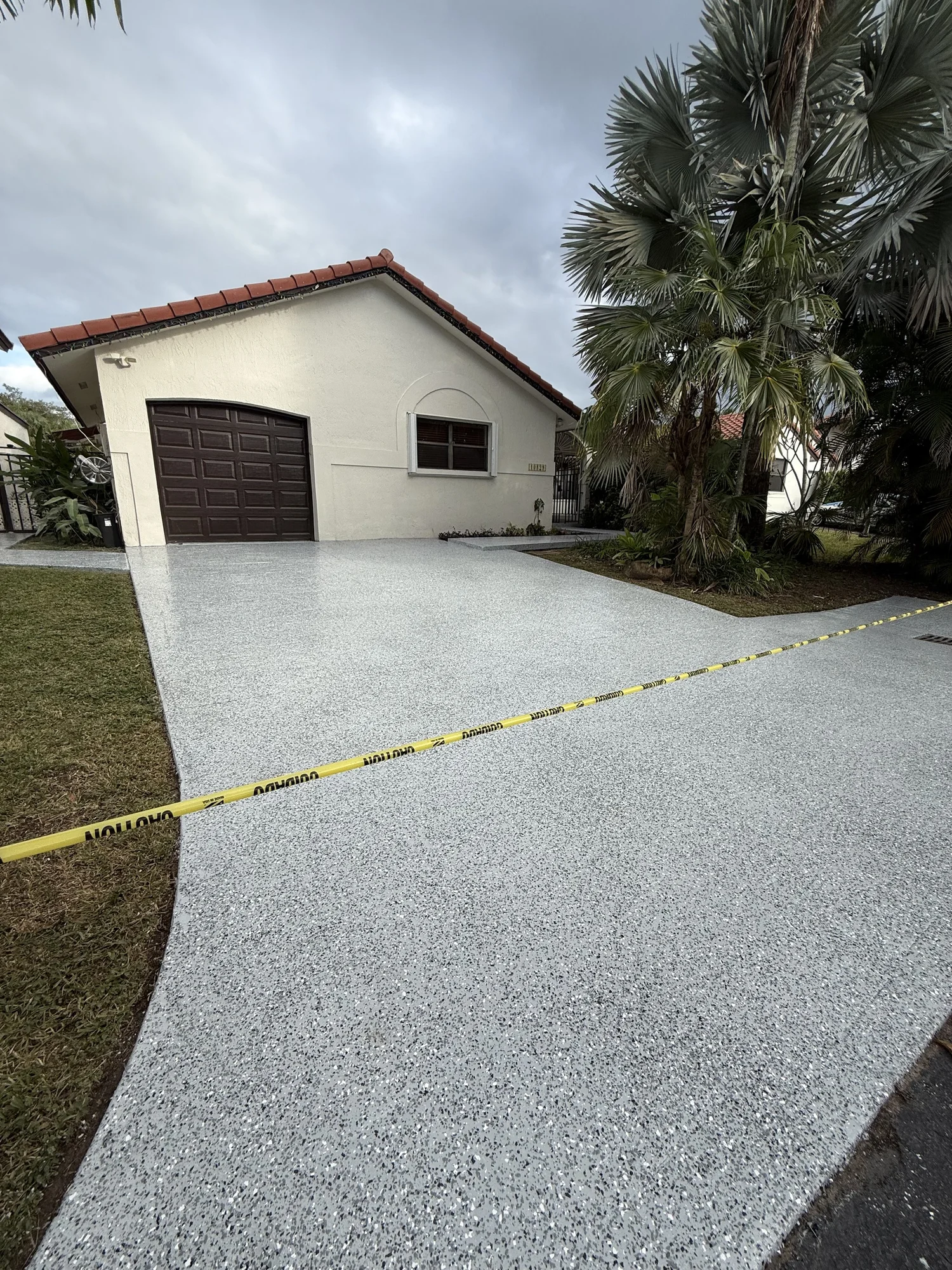 Front of a home with a coated carport and driveway