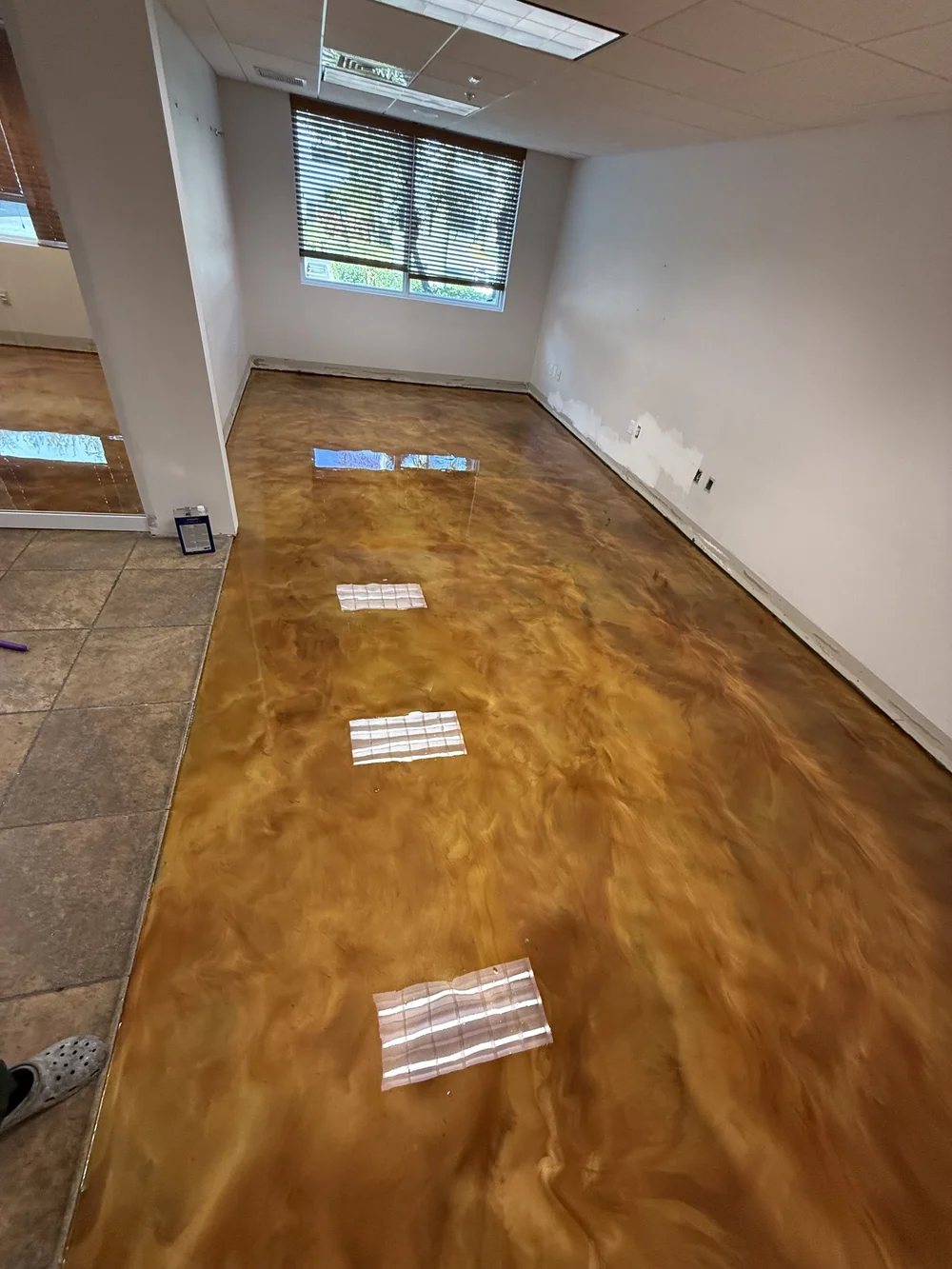 Metallic floor reflecting window light