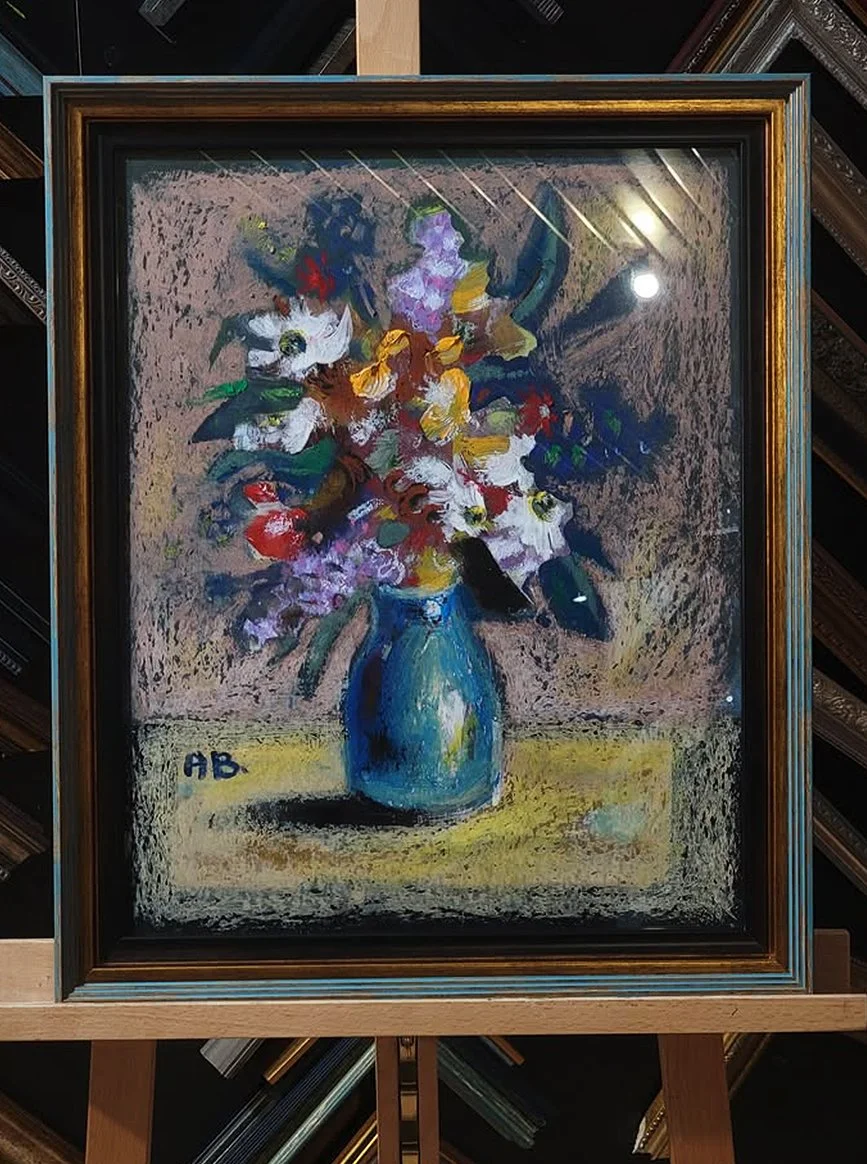 Painting of a bouquet of colorful flowers in a blue vase, signed with initials 'AB' in the lower left corner.