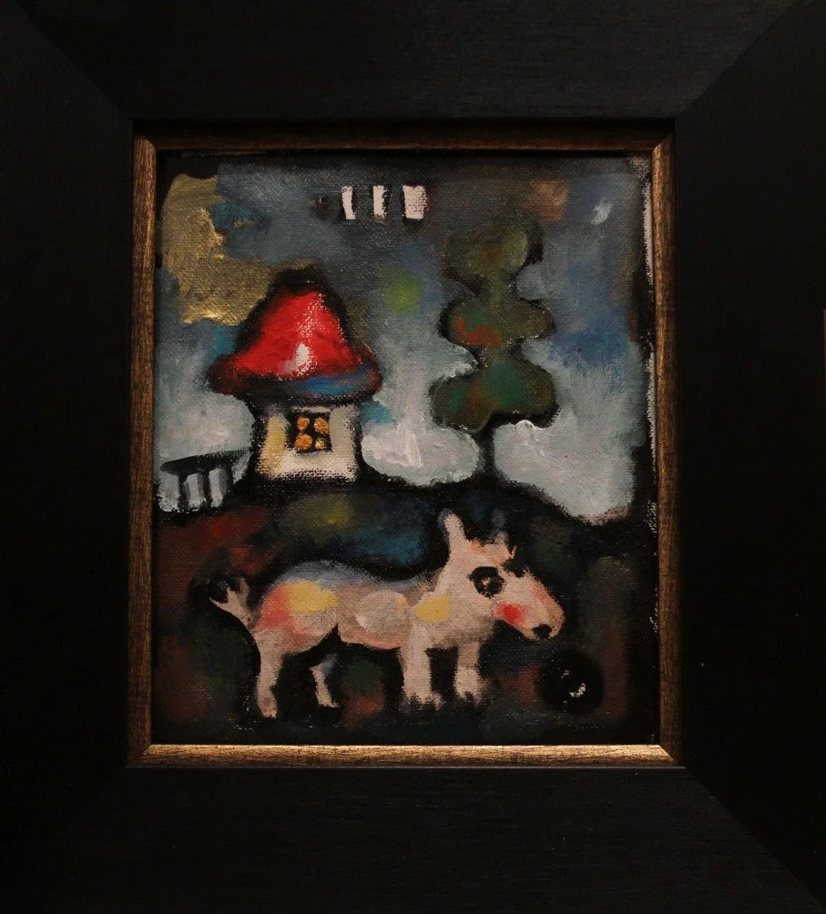 A small framed painting depicting a house with a red roof, a wolf, and trees, painted in an abstract, colorful style.