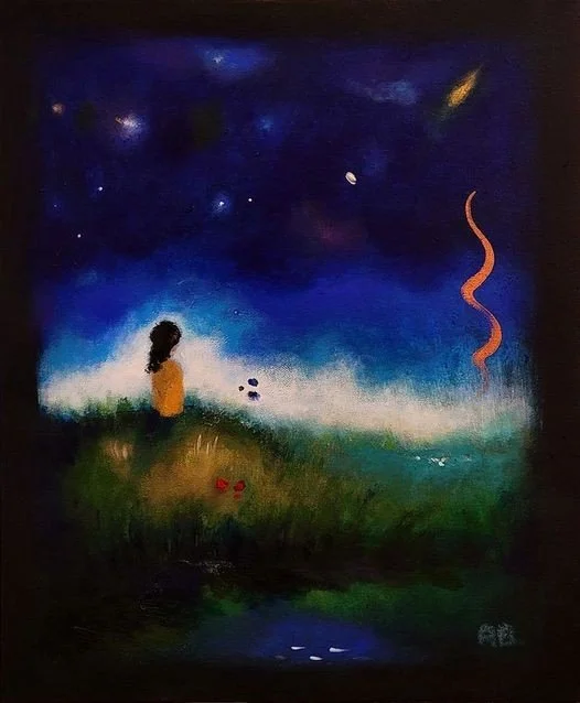 A person with long dark hair sitting on grass, gazing at a starry night sky filled with stars and a distant comet. The scene is calm with a small body of water reflecting some of the night sky.