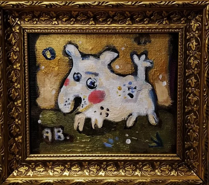 A children's painting of a white, cartoonish dog with big eyes and red cheeks, enclosed in an ornate gold frame.