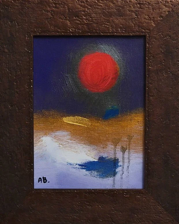 Abstract painting of a contemporary artist Anton Balanchivadze featuring a large red circle resembling the sun or moon in a dark blue sky, with a landscape of earthy tones and white, blue, and gold accents at the bottom 