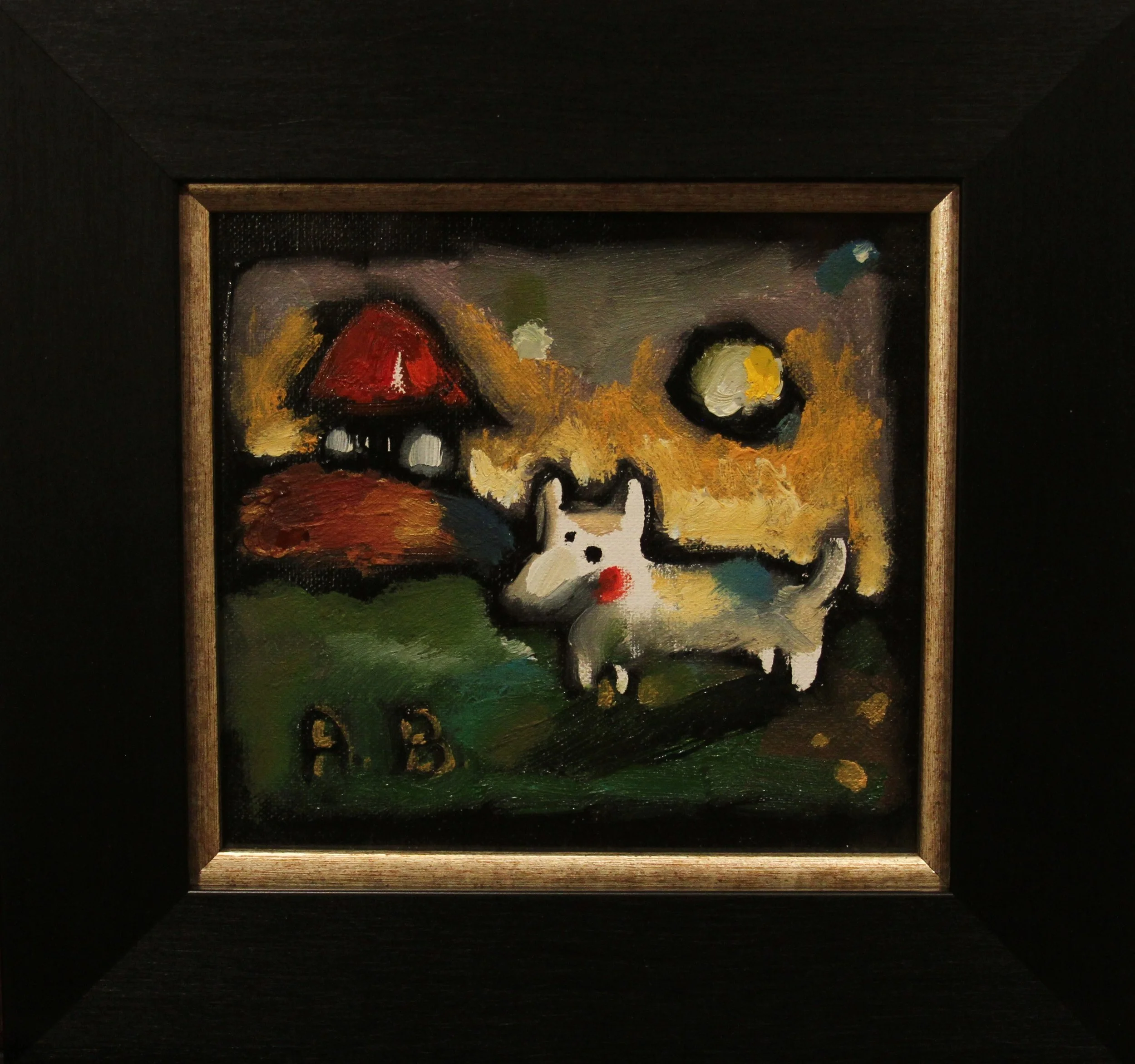 Abstract painting of a dog with a red nose and two black eyes standing on a green patch with yellow accents, a red rooftop house in the background, and a large yellow circle representing the sun or moon, with the scene framed in a wooden border.