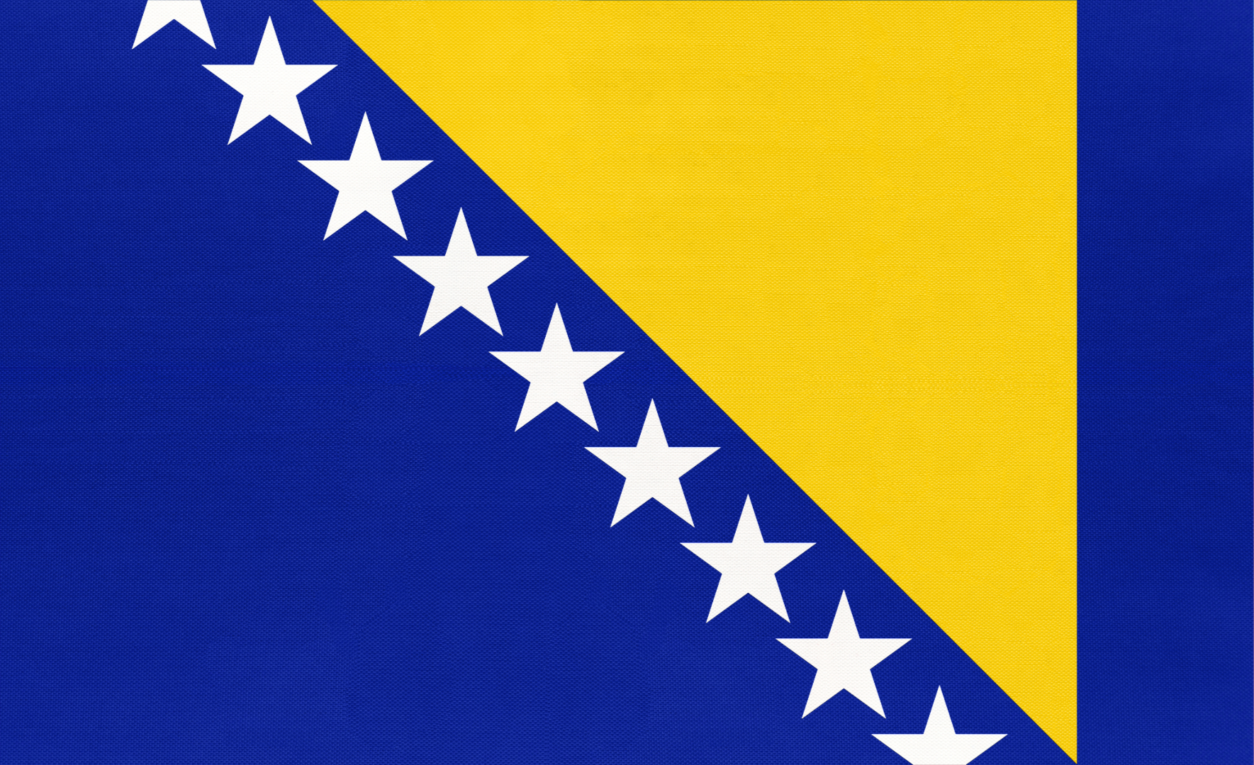 Flag with a blue diagonal split, featuring a yellow triangle in the top right and a blue triangle in the bottom left, with white stars along the diagonal dividing line.