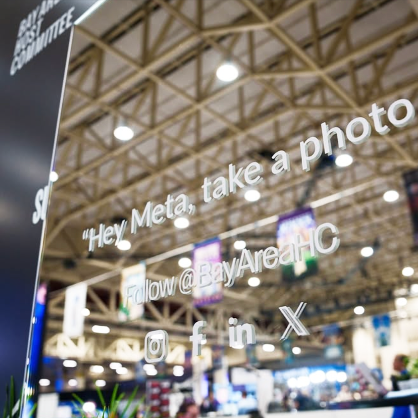 Sign with social media handle and message at an event, encouraging people to take photos and follow on various platforms