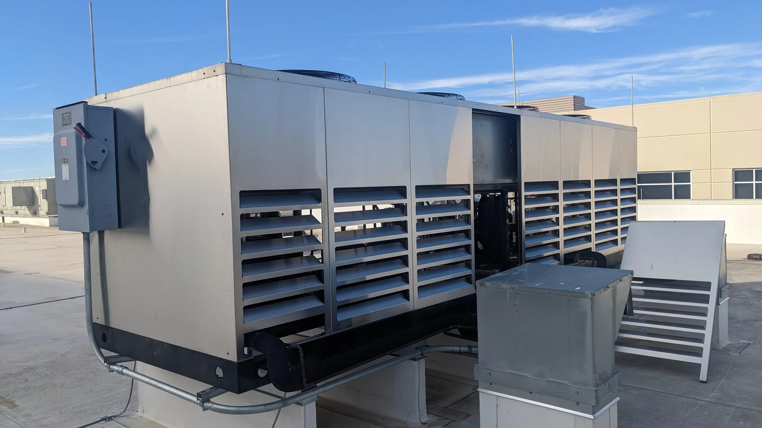 Technician servicing commercial refrigeration equipment