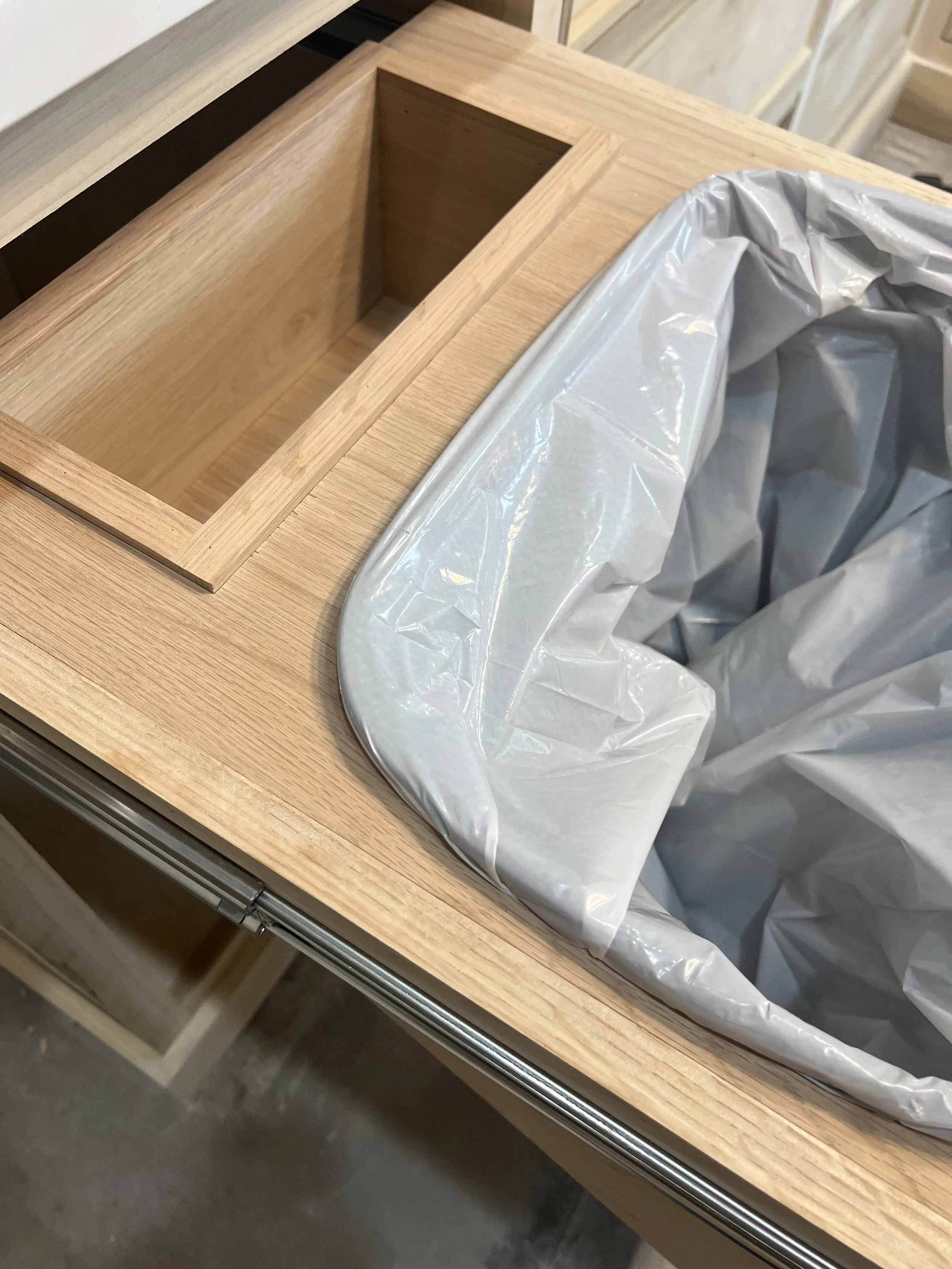 Bag slot on pull out trash can