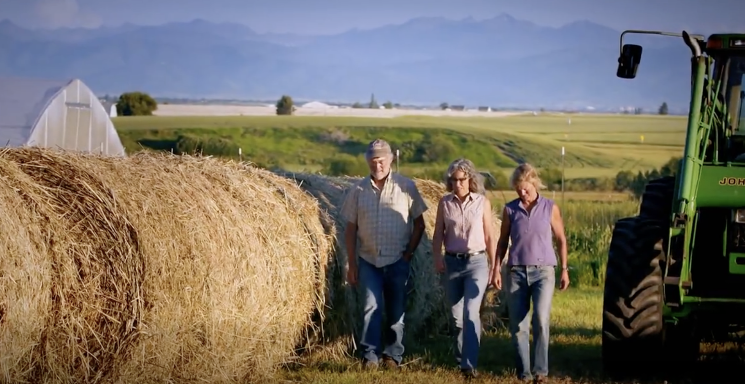 Kathleen Williams walking with farmers on their land, discussing agriculture and working landscapes in Montana.