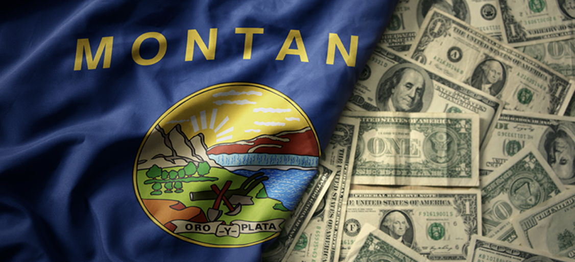 The Montana state flag with dollar imagery, representing the importance of fair tax policy and protecting Montana families and ratepayers.