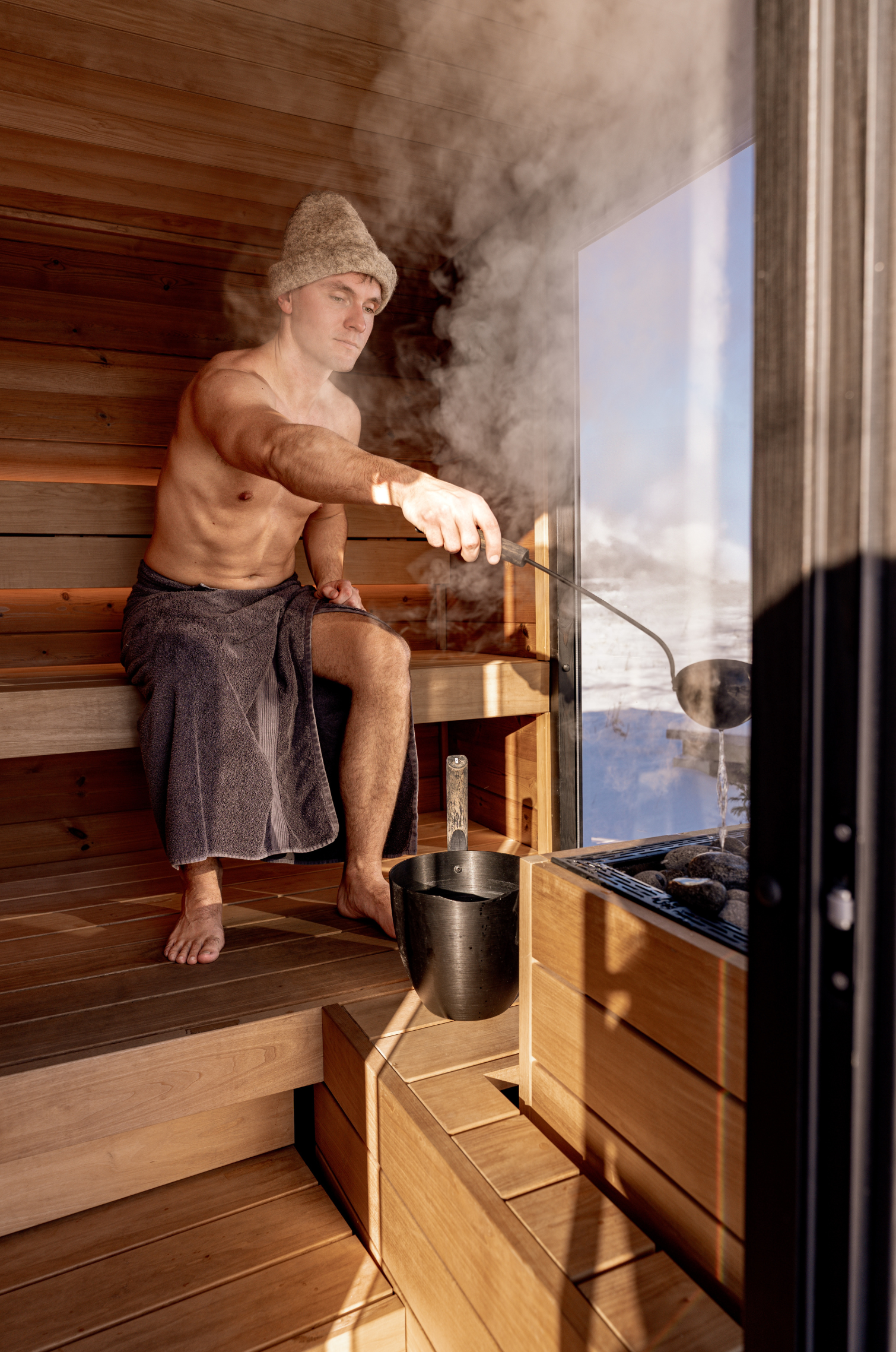 Man in a Nordic Sauna - Building a Nordic Sauna on Utah will unlock your wellness routine and bring you happiness for years to come.