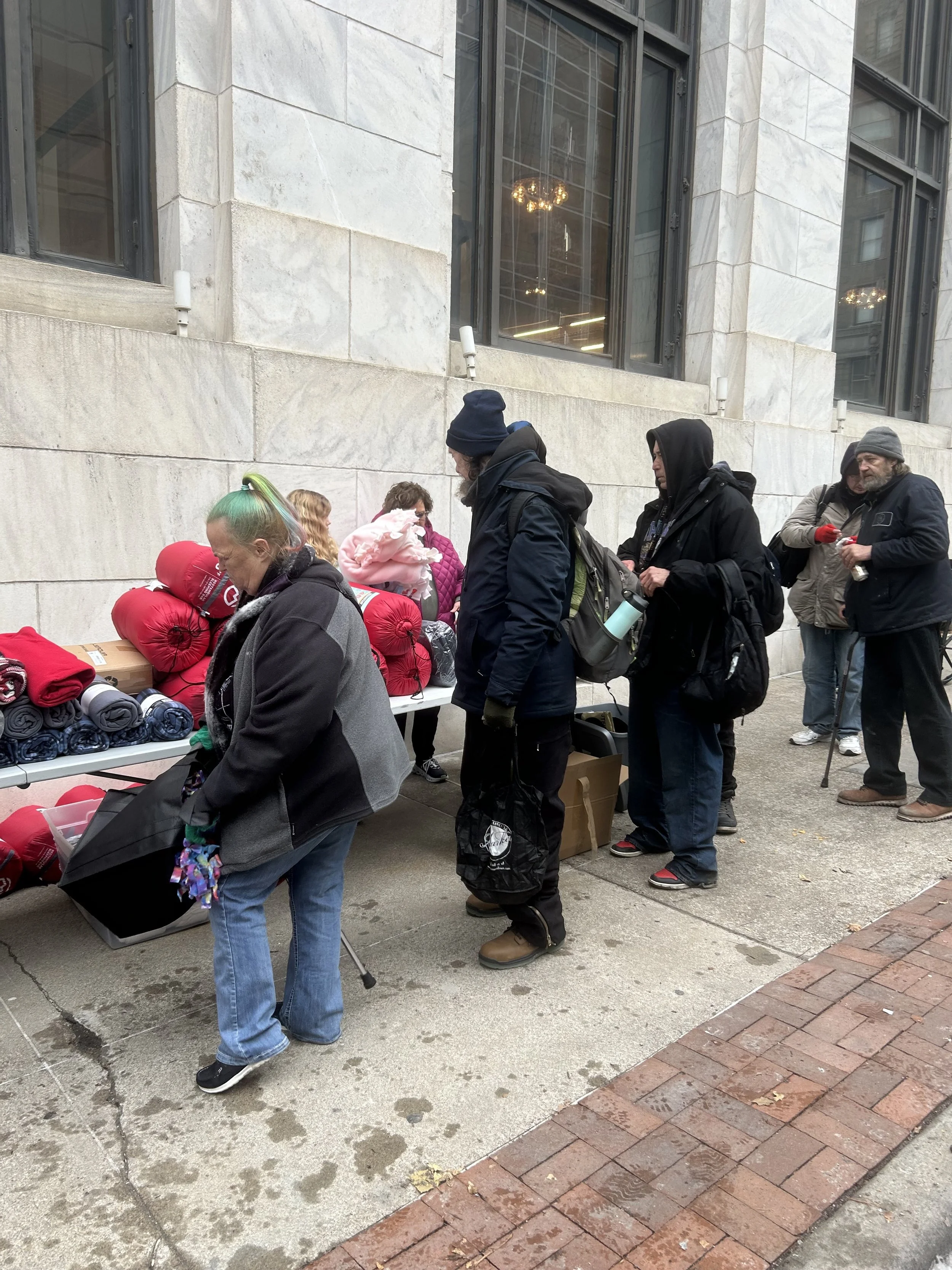 People in a line at a Street Support KC event in Kansas City.