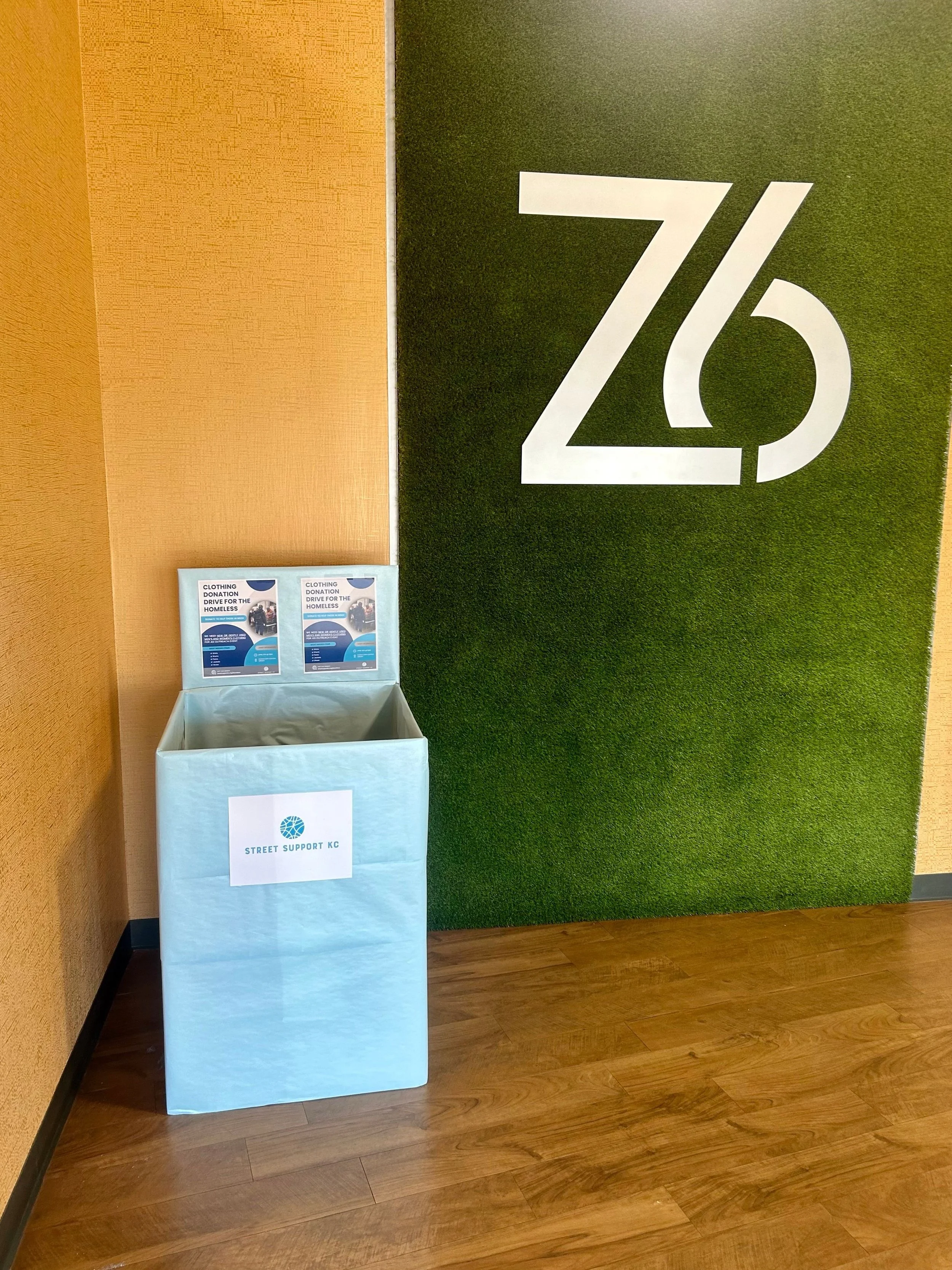 A donation bin labeled 'Street Support KC' at Zone 6 Fitness.