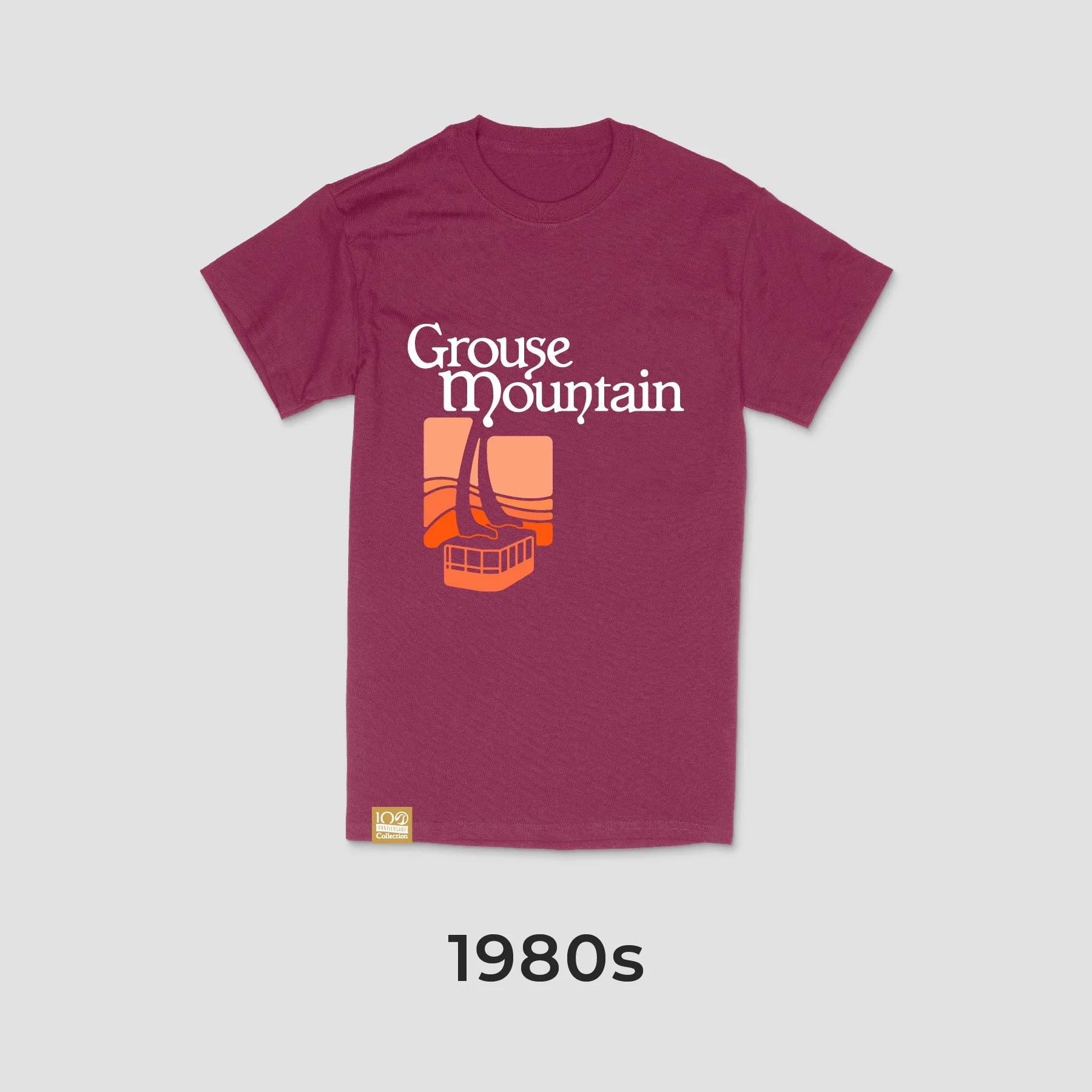Maroon T-shirt with a graphic and text design, reading 'Grouse Mountain' with a stylized illustration of a mountain and cable car, from the 1980s.