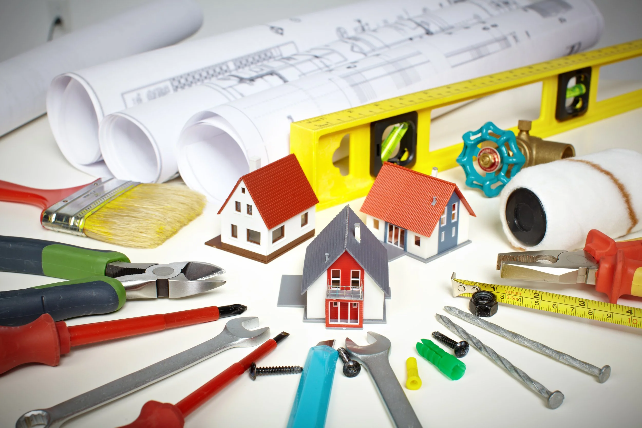 Model houses, blueprints, and various construction tools on a white surface. Home Design, Custom Builder, Blueprints, Construction, Residential,