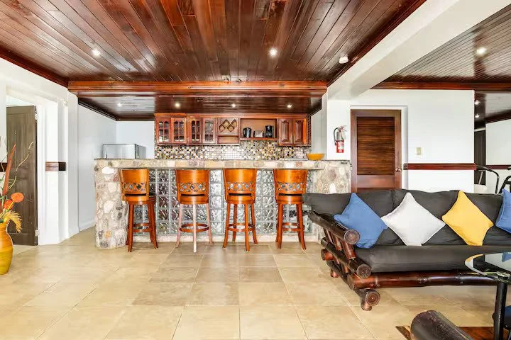 Cozy living room with stone bar counter and wooden accents.