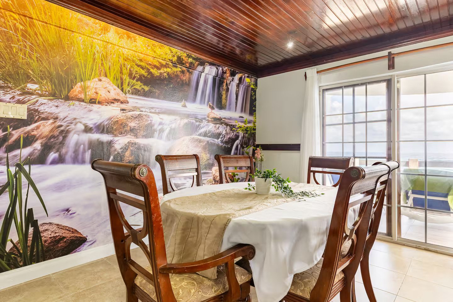 Dining Room with waterfall mural and natural light.