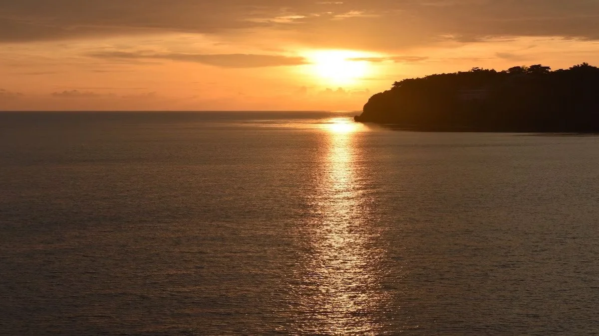 Caribbean Sunset over calm ocean waters.