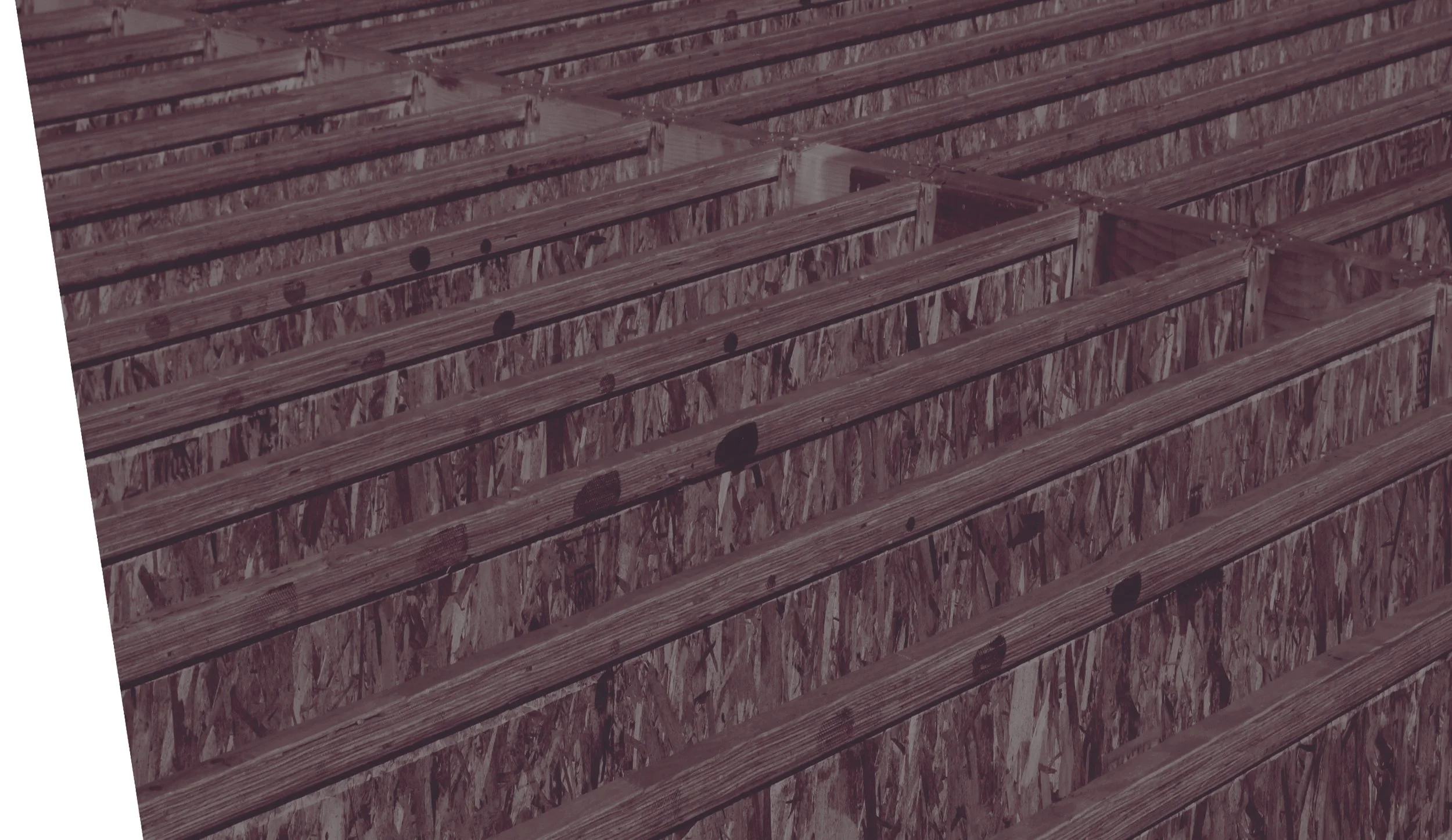 Construction framework with wooden beams and screws, showing a partially built wall or roof in progress.