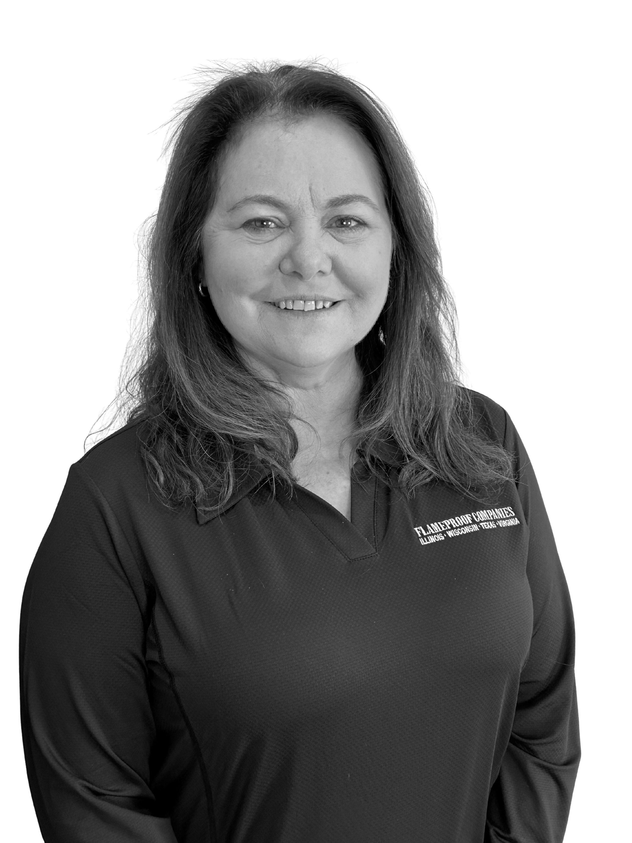 A man in a blue sweater sitting on a beige bench with a neutral background and soft lighting.