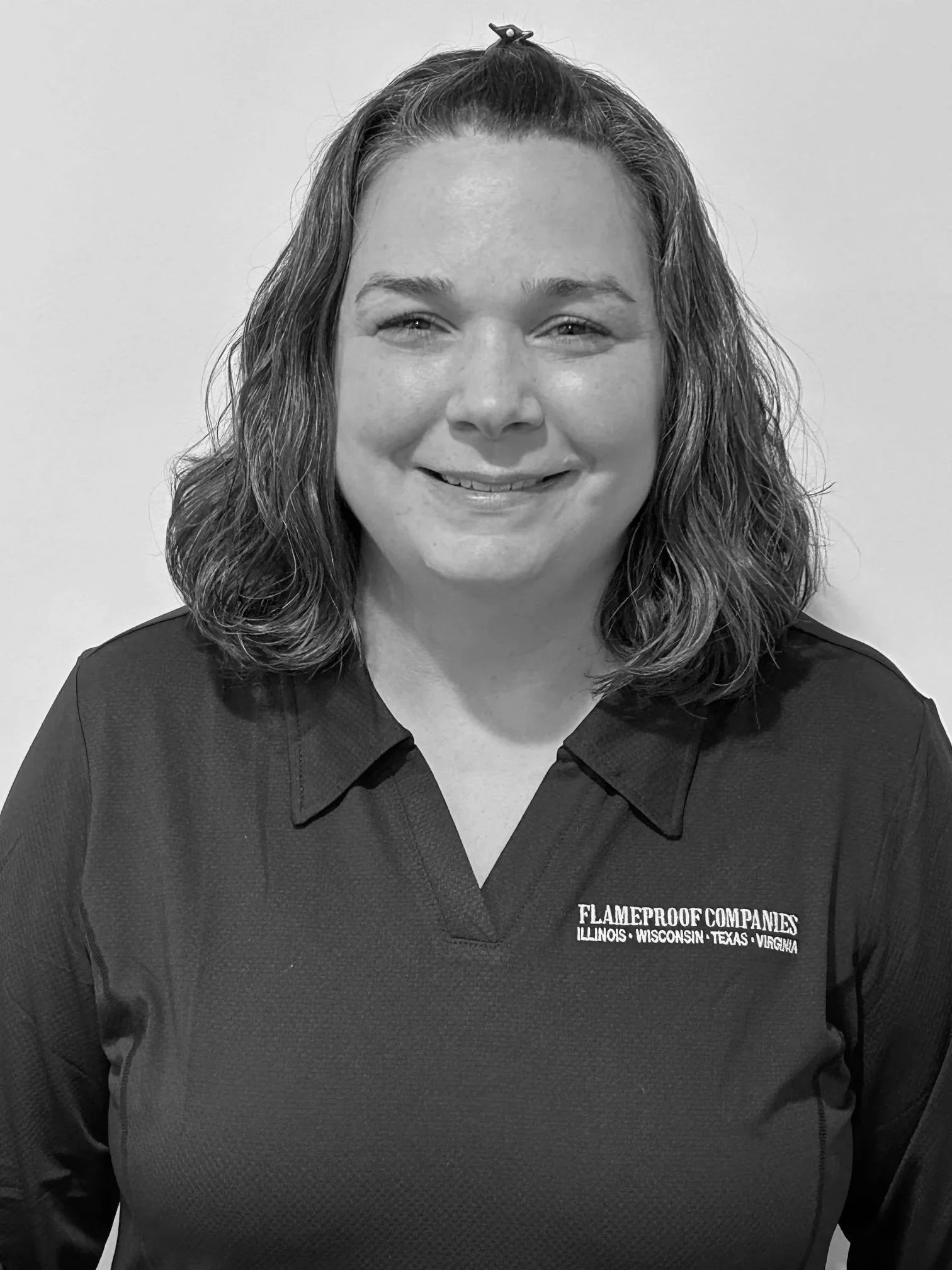 Woman sitting on a bench writing in a notebook in a well-lit room with a framed abstract painting leaning against the wall.