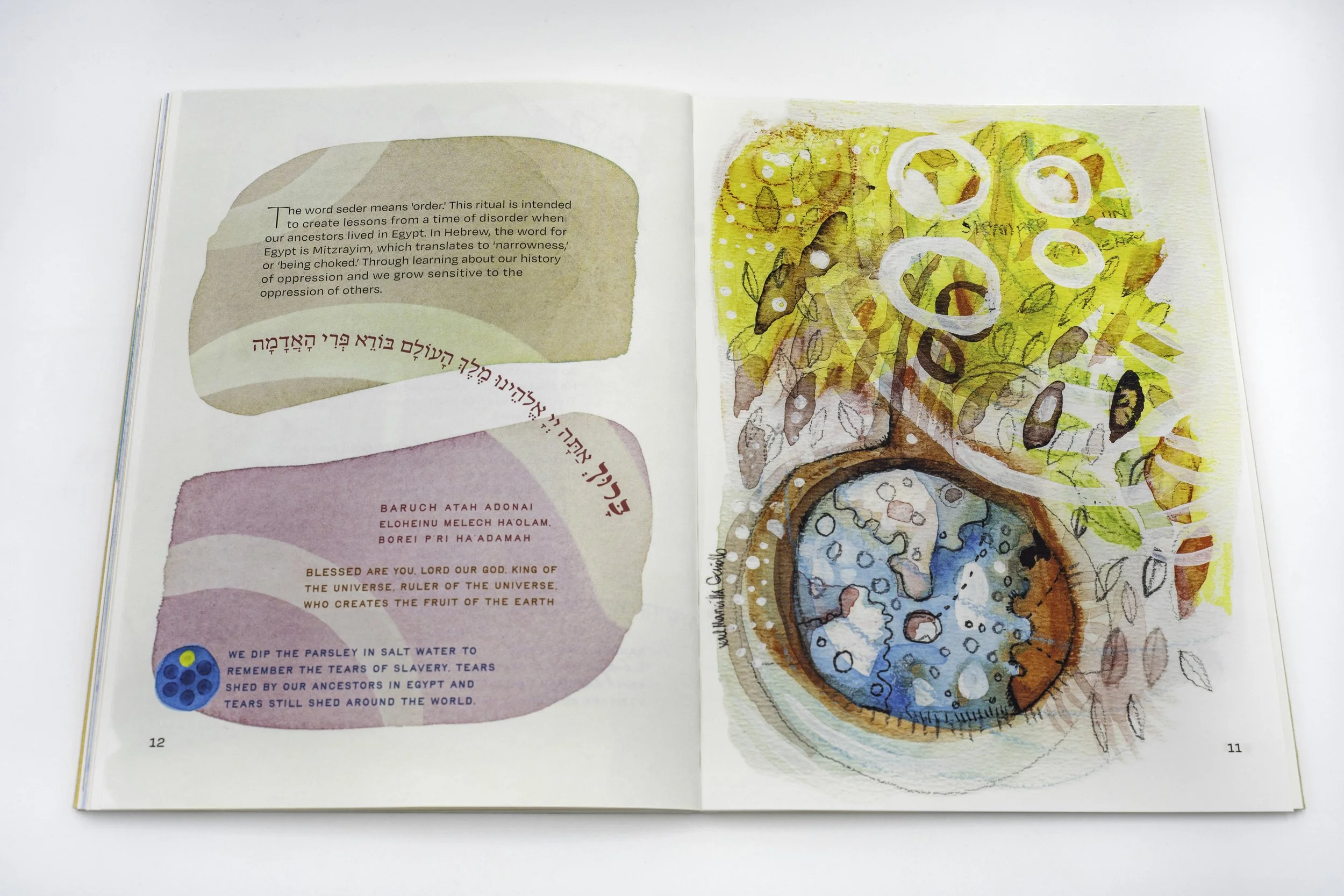 Open book with abstract watercolor illustrations illustrating disorder and order during passover seder. Text is discussing ancient rituals, history of oppression, and symbolic imagery of Jewish Passover