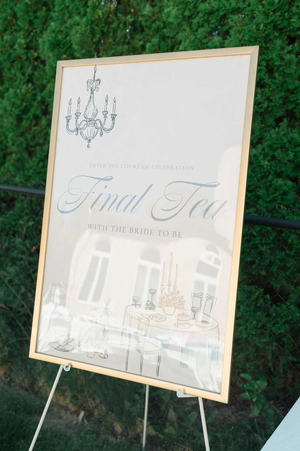 A wedding sign with elegant writing and illustrations including a chandelier and a decorated table with candles, a cake, and drinks, welcoming guests to the "Final Tea" celebration.