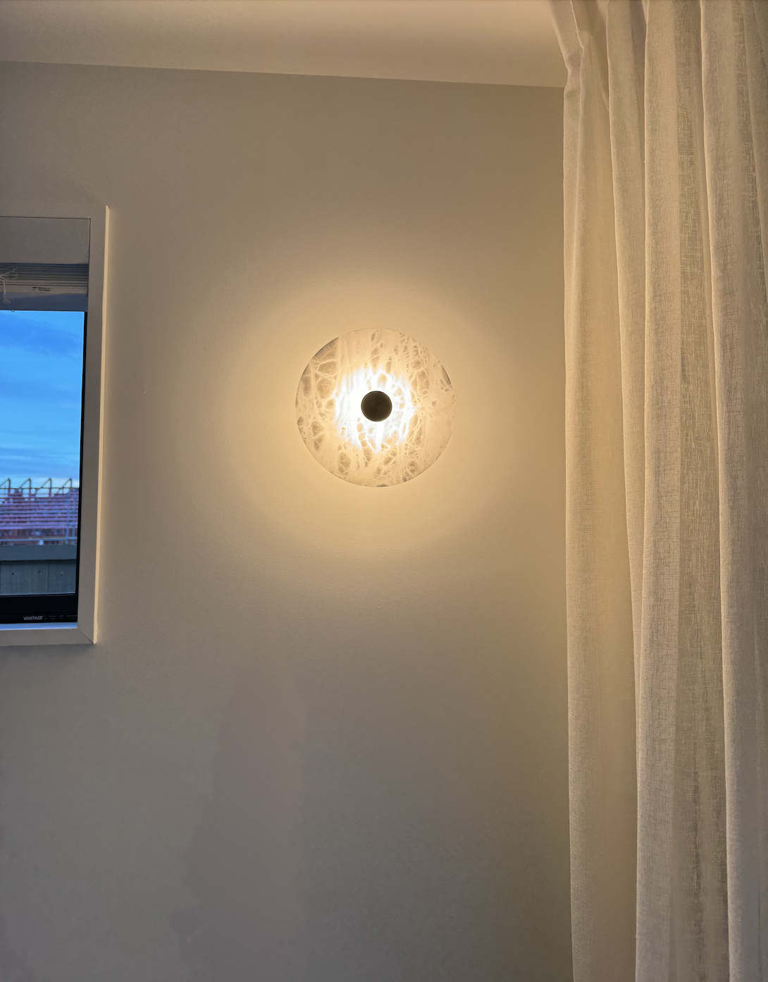 Brushed brass wall light adding warm ambient lighting to a contemporary interior