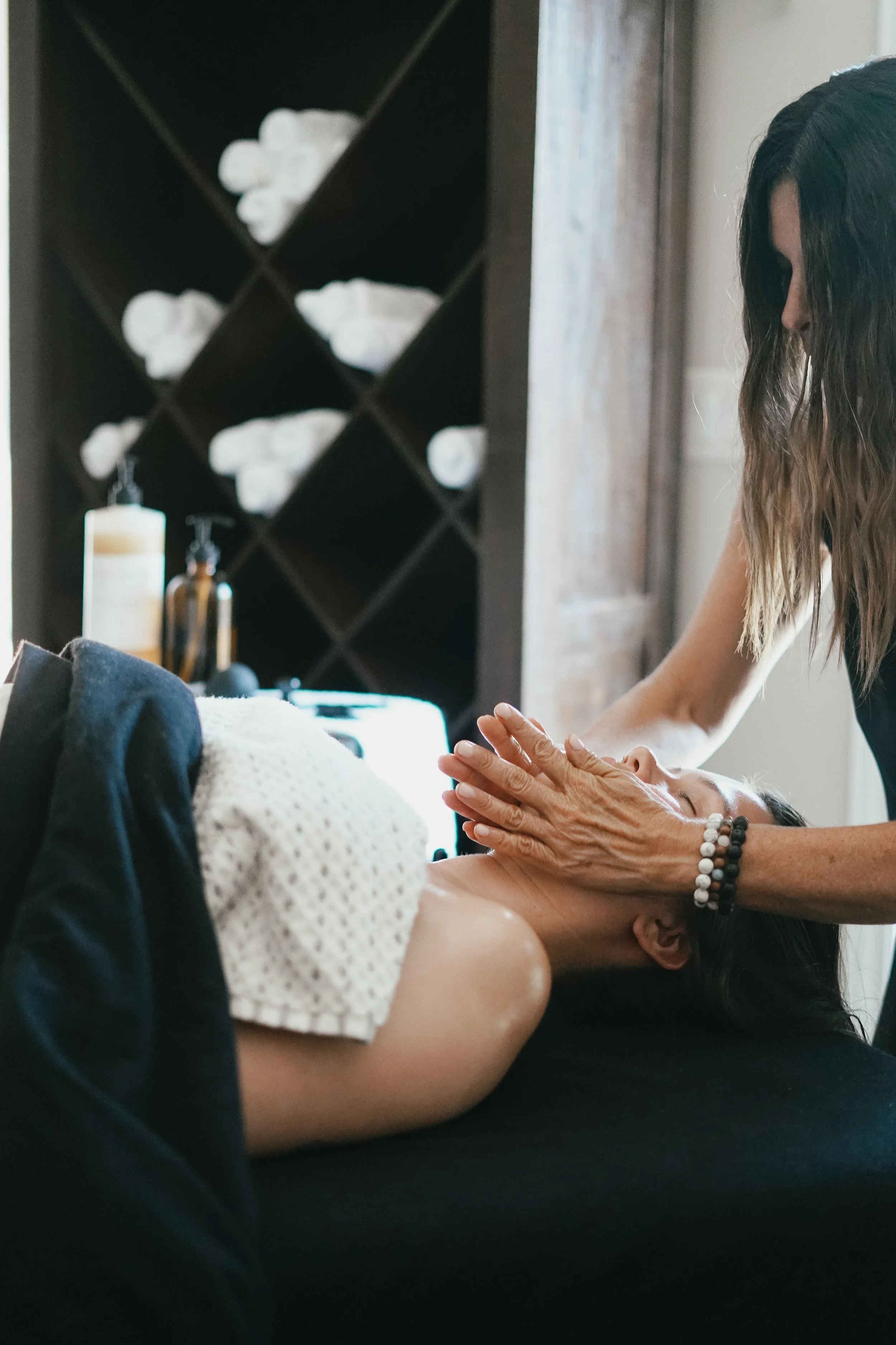 Woman receiving a facial massage at a spa or wellness center. Booking a glow state facial in stratford ontario.