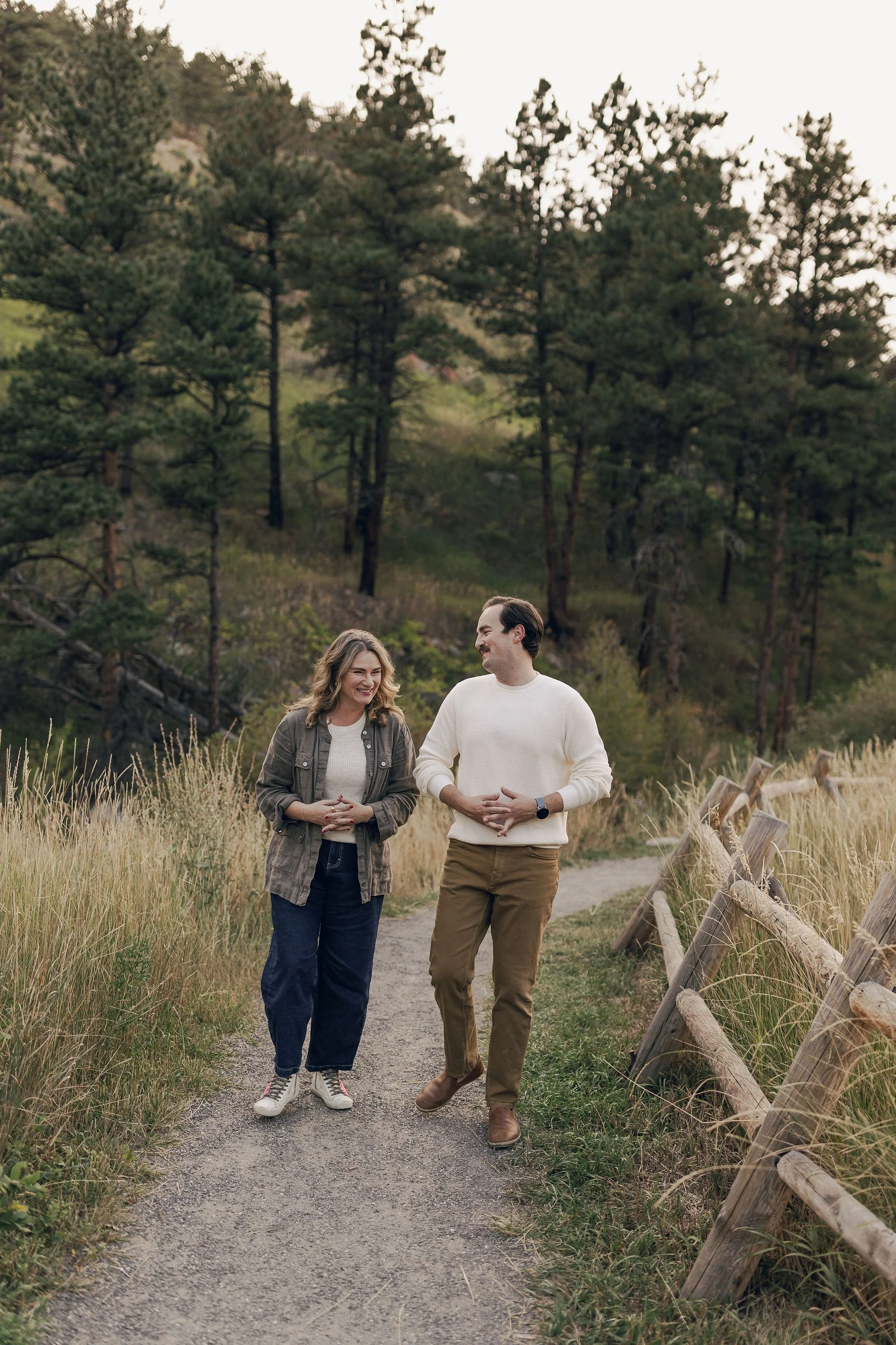 Jill Krush and Gabriel walking on a trail together in a mountain meadow, reflecting the grounded, relational nature of Ginkgo Way Leadership Coaching.