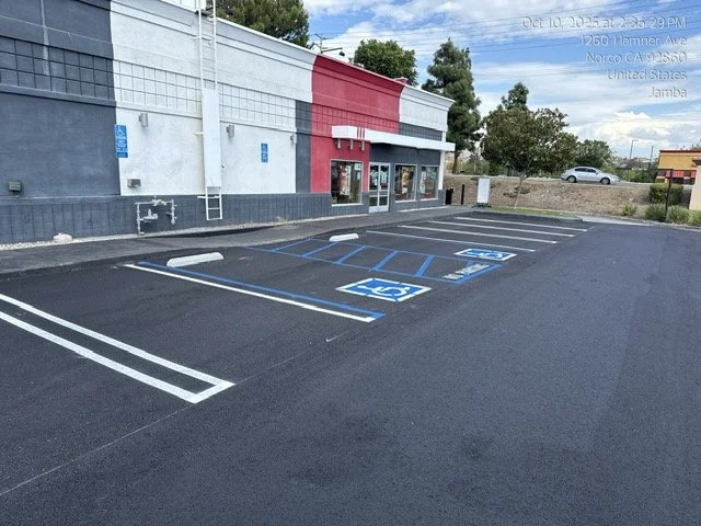Empty parking lot with designated handicapped parking spaces in front of a building. ADA parking, ADA compliance