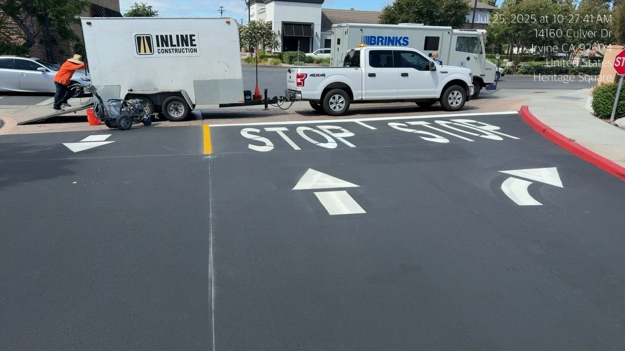 Street with painted stop line and directional arrows.