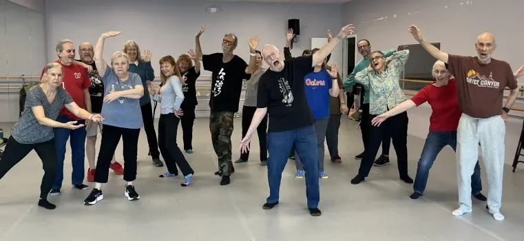 Group of elderly people dancing and having fun in a dance studio