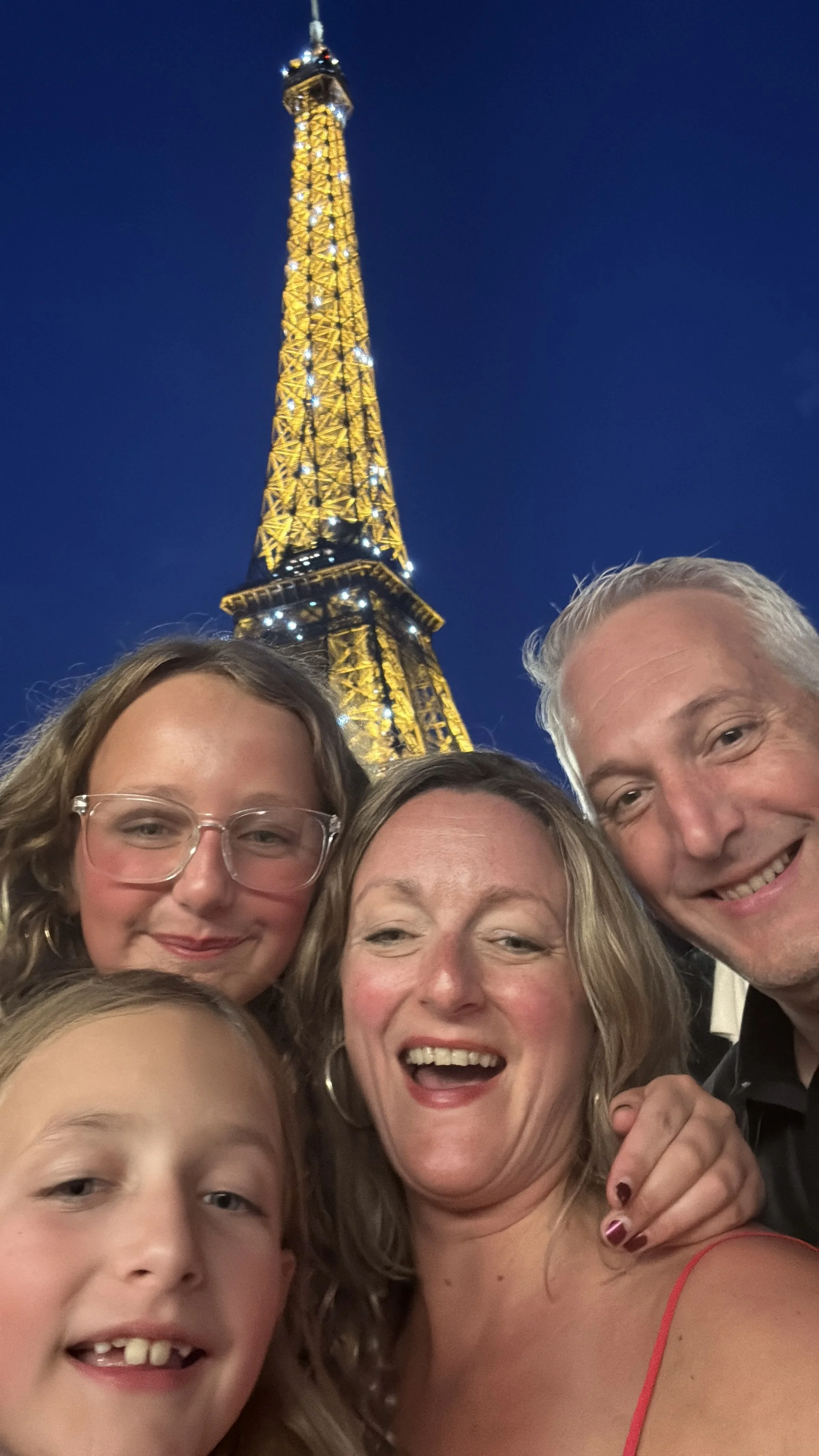 our family using points and miles to travel to Paris and see the eiffel tower at night