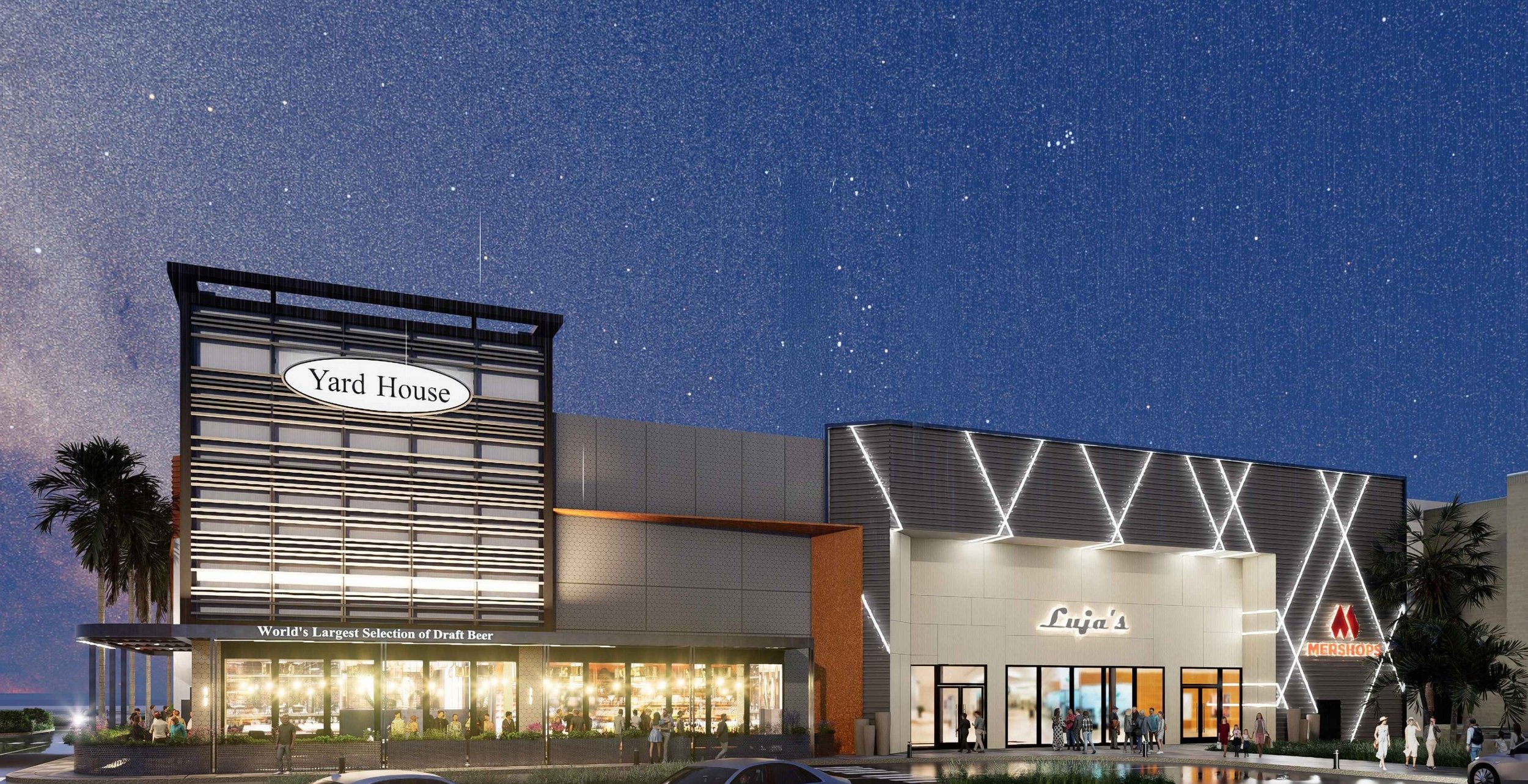 Nighttime scene of a modern shopping center with multiple stores, including Yard House and Luja's, under a starry sky. The Yard House has a large sign, and the building features a facade with illuminated lines. Structural engineering by BASE Design.