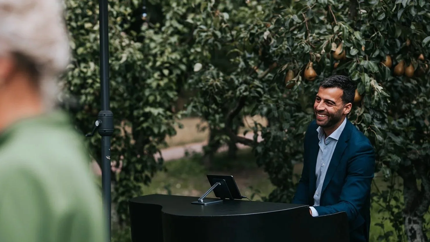 Glimlachende pianist op een bruiloft in de zomer. Muzikanten van Mr. Allegaartje