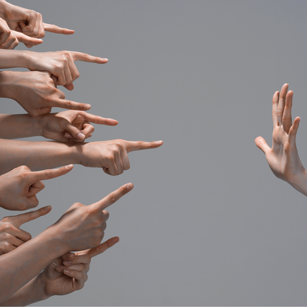 A hand help up with several hands all pointing fingers at it