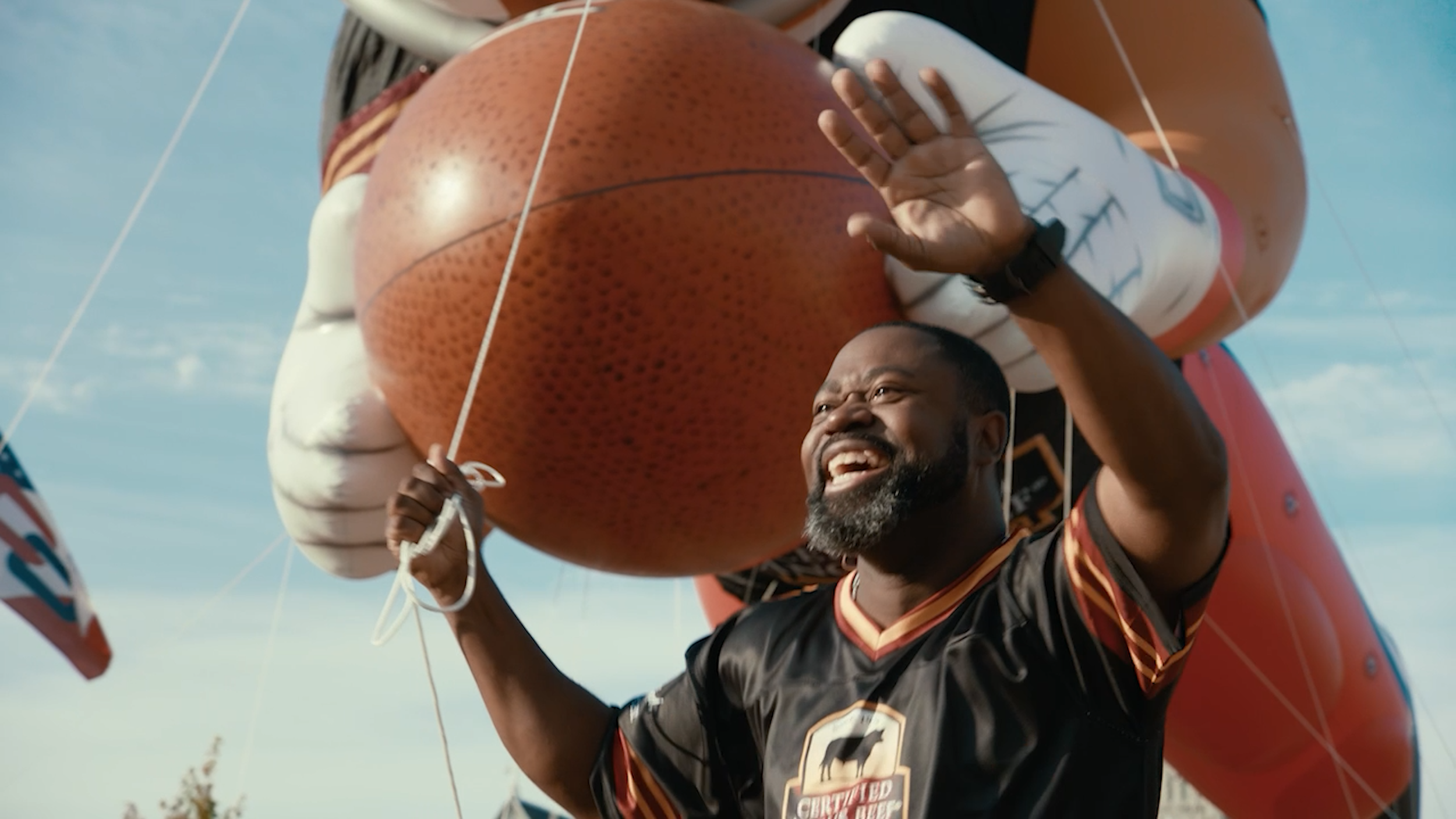 Grilled salmon fillet on a white plate served with roasted potatoes, broccoli, cherry tomatoes, and green beans on a wooden table.Professional basketball player smiling beneath an oversized basketball during a commercial campaign shoot.