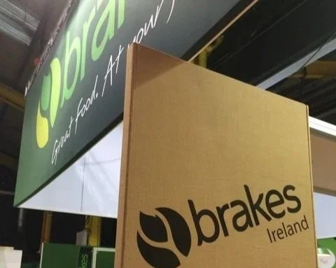 Brakes exhibition stand. Image shows the brand represented on two different surfaces. A hessian finish and large overhead expo banner for maximum graphic impact at high level.