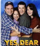 Four people hugging and smiling against a blue background, with text saying 'YES, DEAR'